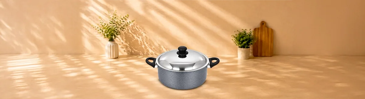 Deep grey non-stick handi with black handles and a domed steel lid