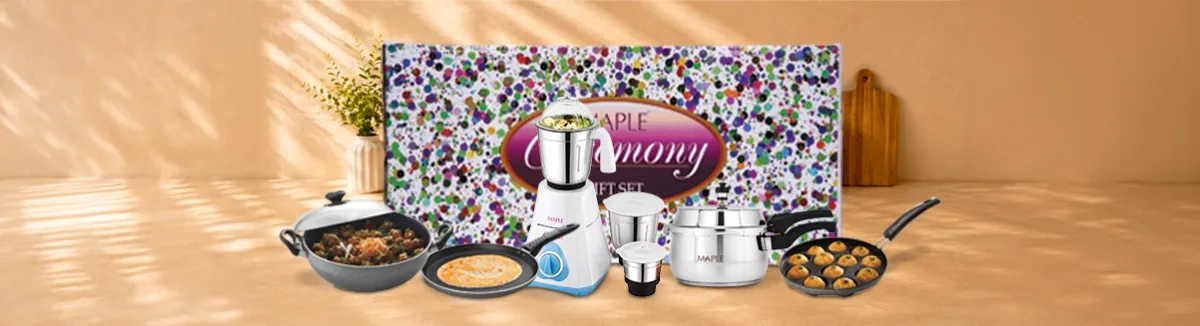 Kadai, tawa, mixer grinder, steel handi and paniyaram pan before a printed box