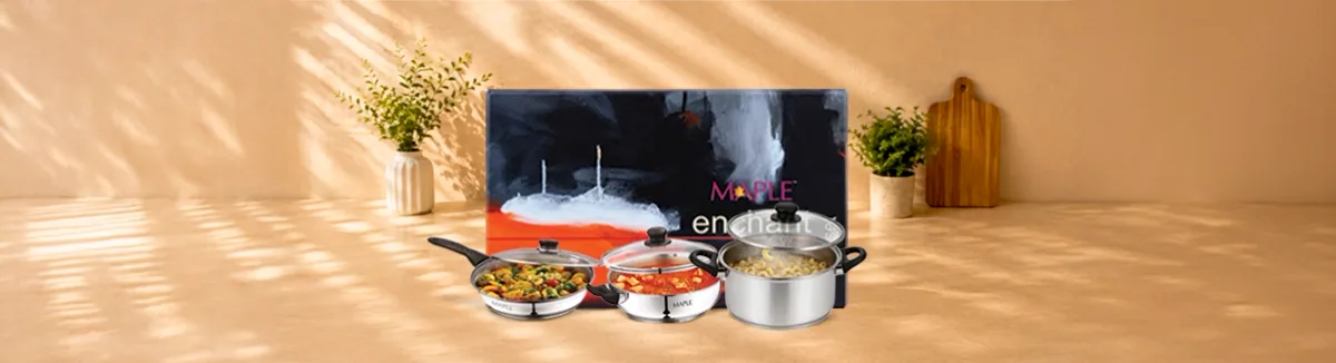 Steel fry pan, kadai and deep pot holding cooked food, dark gift box behind