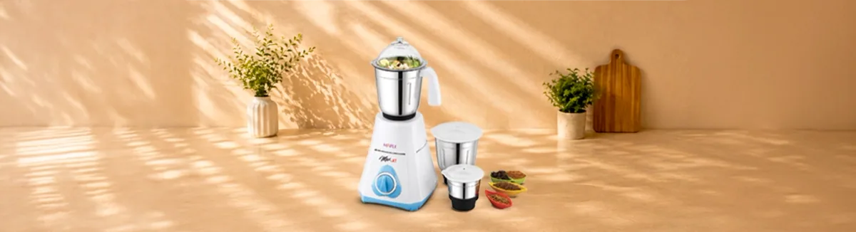 White and blue mixer grinder with three jars and spices set out beside it