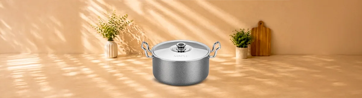 Grey non-stick handi with steel side handles and a steel lid