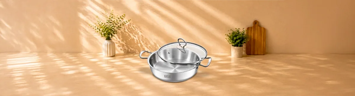 Steel kadai with two side handles and a glass lid set on top