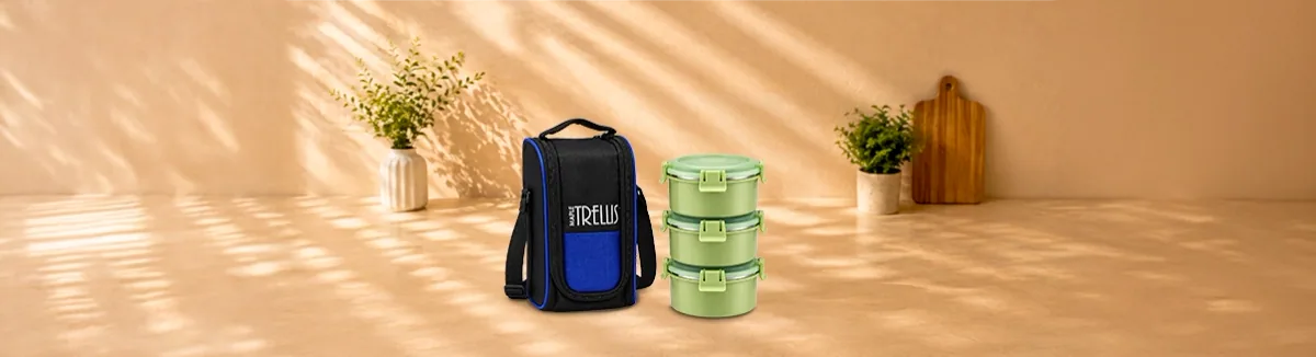 Black and blue insulated bag beside three stacked green containers
