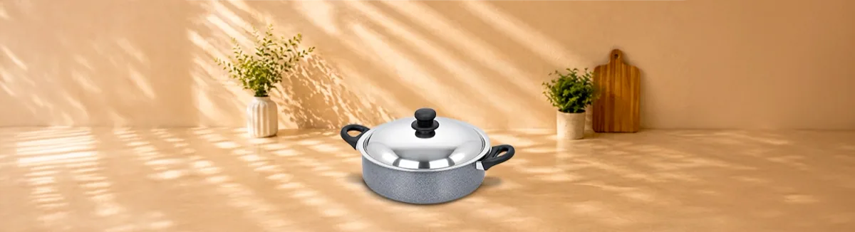 Grey non-stick pan with black handles and a domed steel lid