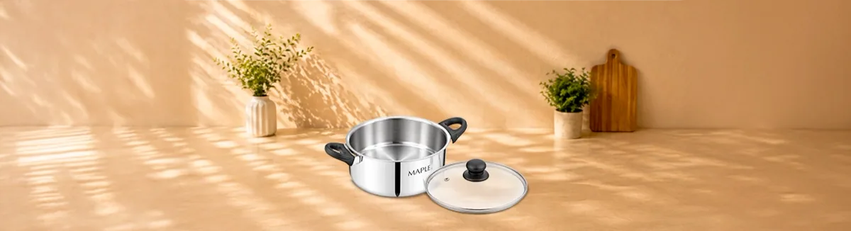 Steel pot with black side handles, its glass lid set alongside