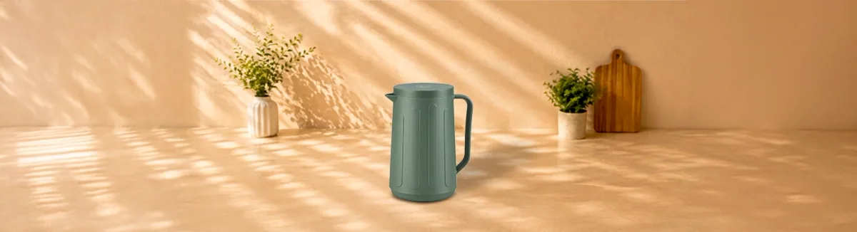 Sage green flask with a ribbed body, pouring spout and side handle