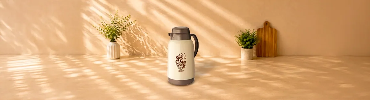 Cream flask with a brown lid, side handle and swirl print, on a counter