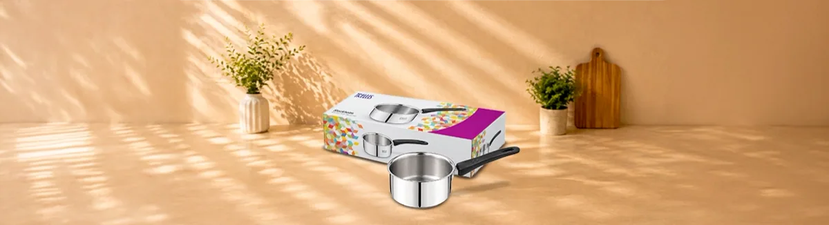 Steel sauce pan with a long black handle, in front of its printed carton